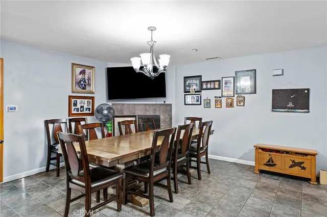 a view of a dining room with furniture and chandelier
