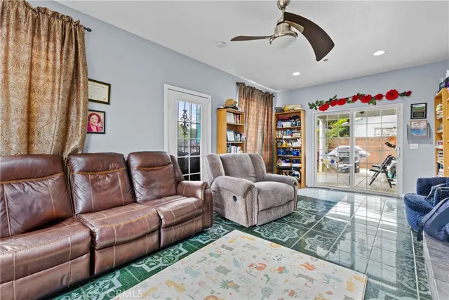 a living room with fireplace furniture and a rug