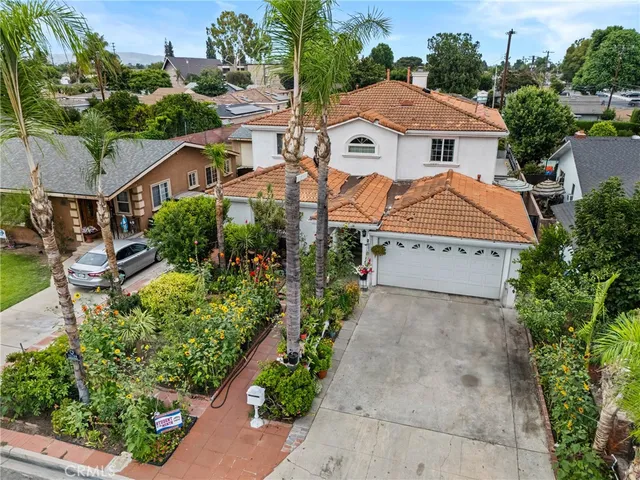 an aerial view of a house with yard and green space