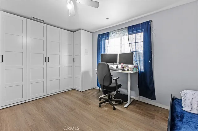 a view of a workspace with furniture and a window