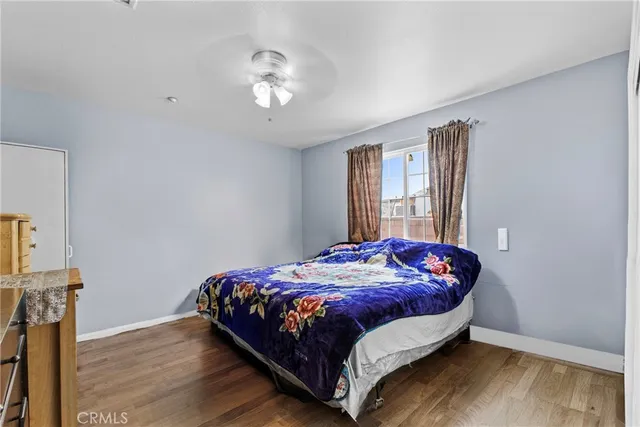 a bed sitting in a bedroom next to a window