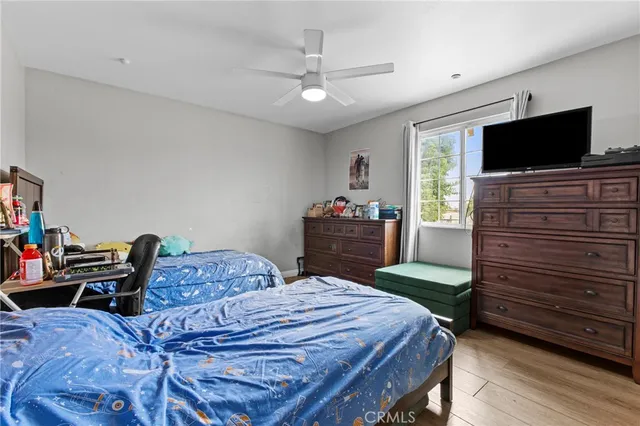 a bedroom with a bed and flat screen tv