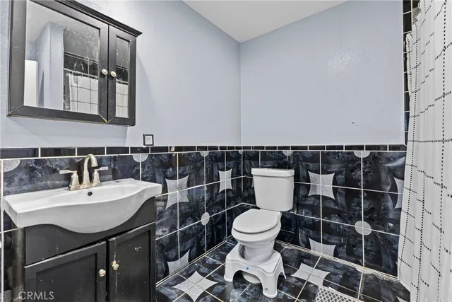 a bathroom with a sink a toilet and a mirror