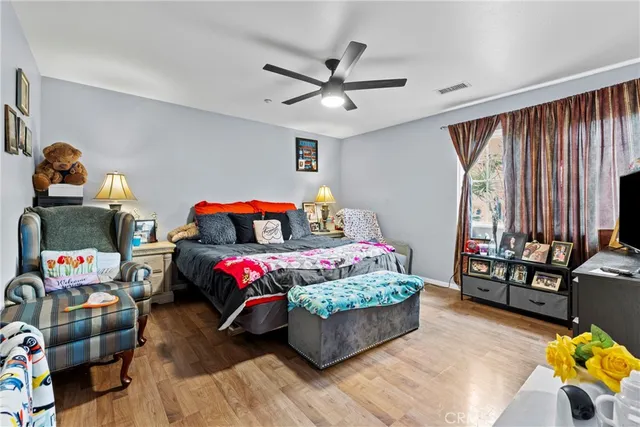 a bedroom with furniture and a wooden floor