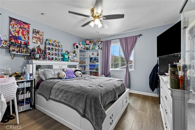 a bed room with a bed and a flat tv screen