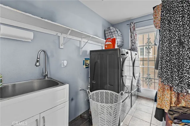 a kitchen with a refrigerator and a sink