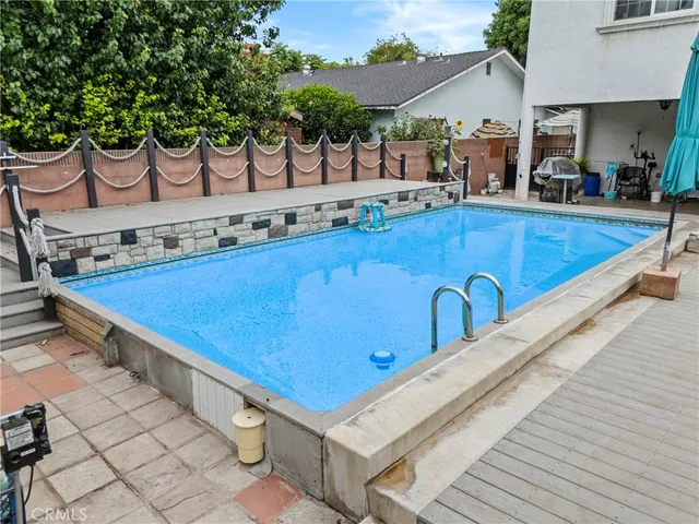 swimming pool view with a seating space