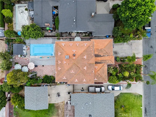 an aerial view of multiple houses with a yard