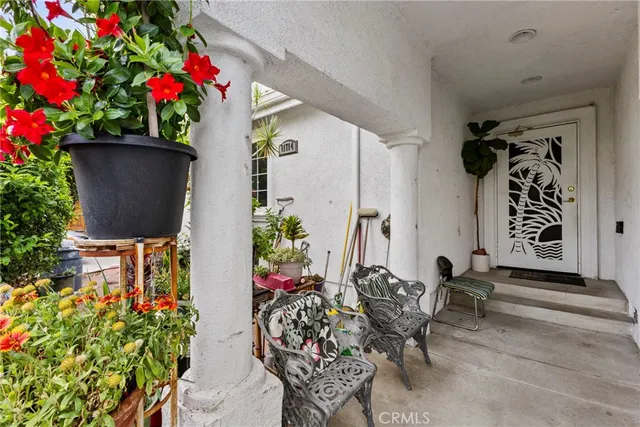 a front view of a house with flower pots