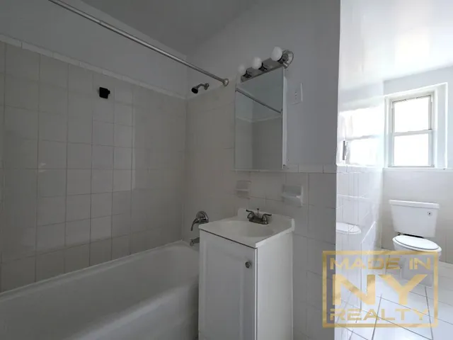 a bathroom with a bathtub a toilet and a shower