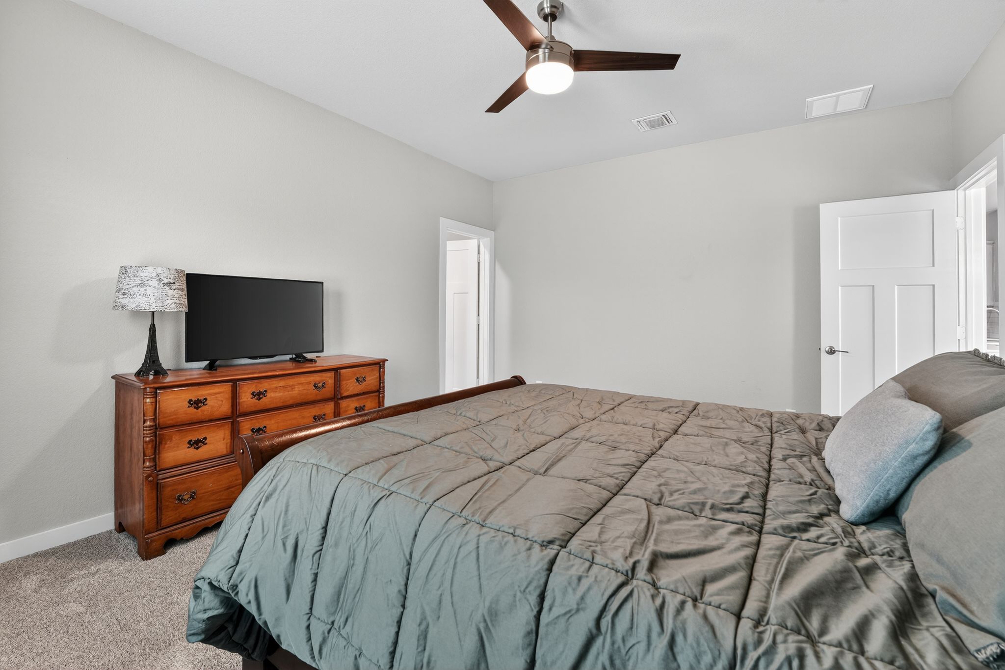 117 Halford Road Georgetown, TX 78633 - Photo 19 of 31 Bedroom featuring a ceiling fan and light colored carpet