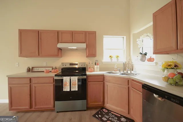 a kitchen with a sink stove and cabinets