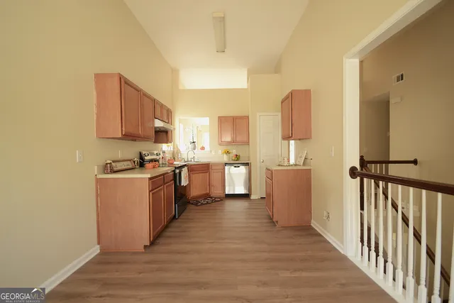 a kitchen with a cabinets and wooden floor