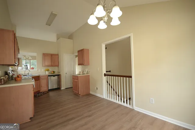 a view of a kitchen with a sink cabinets and wooden floor