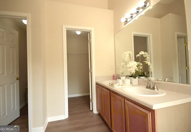 a bathroom with a tub sink and mirror