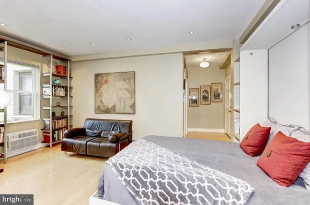 a bedroom with furniture and a book shelf