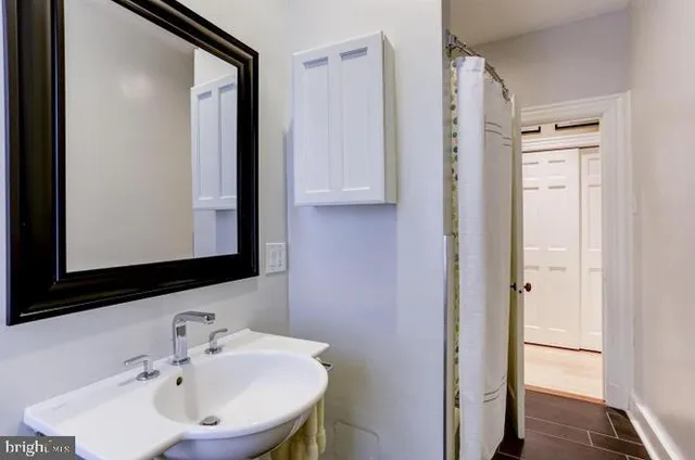 a bathroom with a sink and a mirror