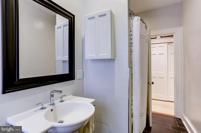 3100 Connecticut Avenue Northwest, Unit 419 Washington, DC 20008 - Photo 14 of 15 a bathroom with a sink and a mirror