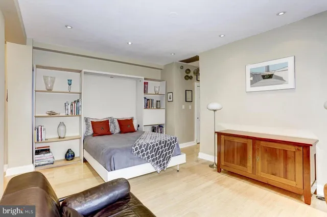 a bedroom with a bed and dresser