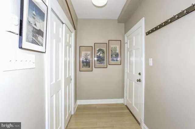 a view of a hallway with wooden floor and windows