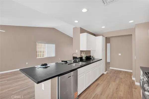 a kitchen with stainless steel appliances kitchen island granite countertop a sink and cabinets