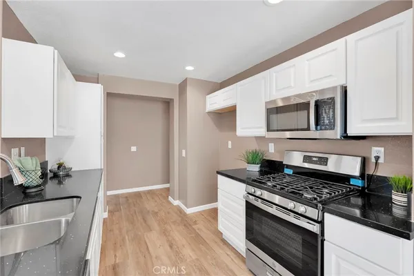 a kitchen with stainless steel appliances granite countertop a stove and a sink