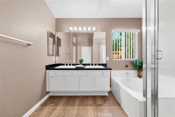 a bathroom with a double vanity sink and a bathtub
