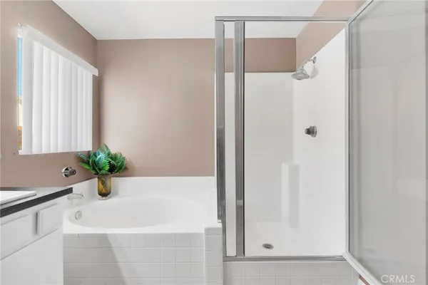 a bathroom with a bathtub and a shower