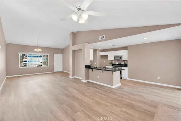 a kitchen with stainless steel appliances kitchen island a refrigerator sink and stove