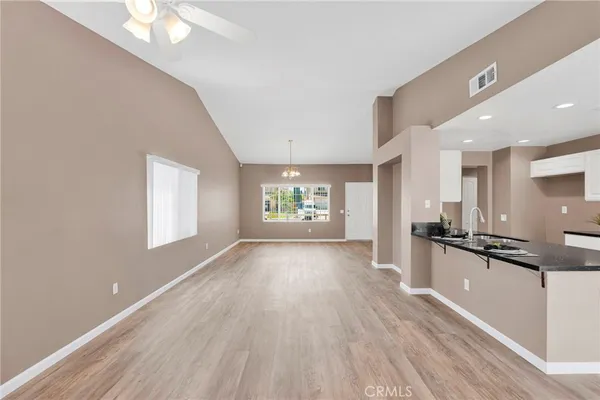 a view of a kitchen with a sink and a stove top oven