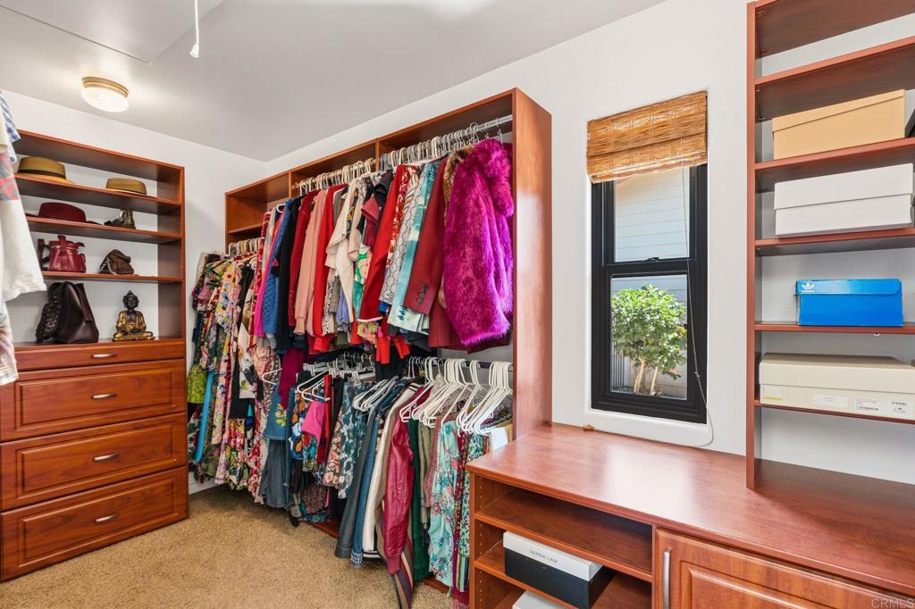 13319 Pacer Lane Poway, CA 92064 - Photo 29 of 75 a view of walk in closet with clothes and shoes