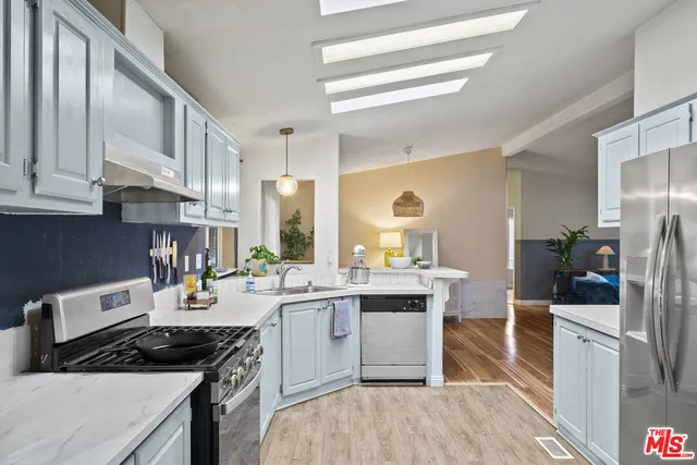 a bedroom with a bed and a painting on the wall