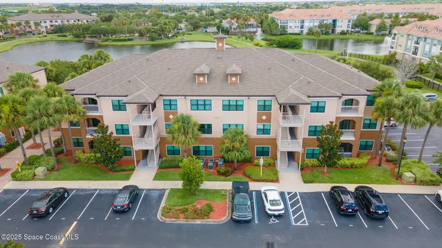 an aerial view of a house with a garden and lake view