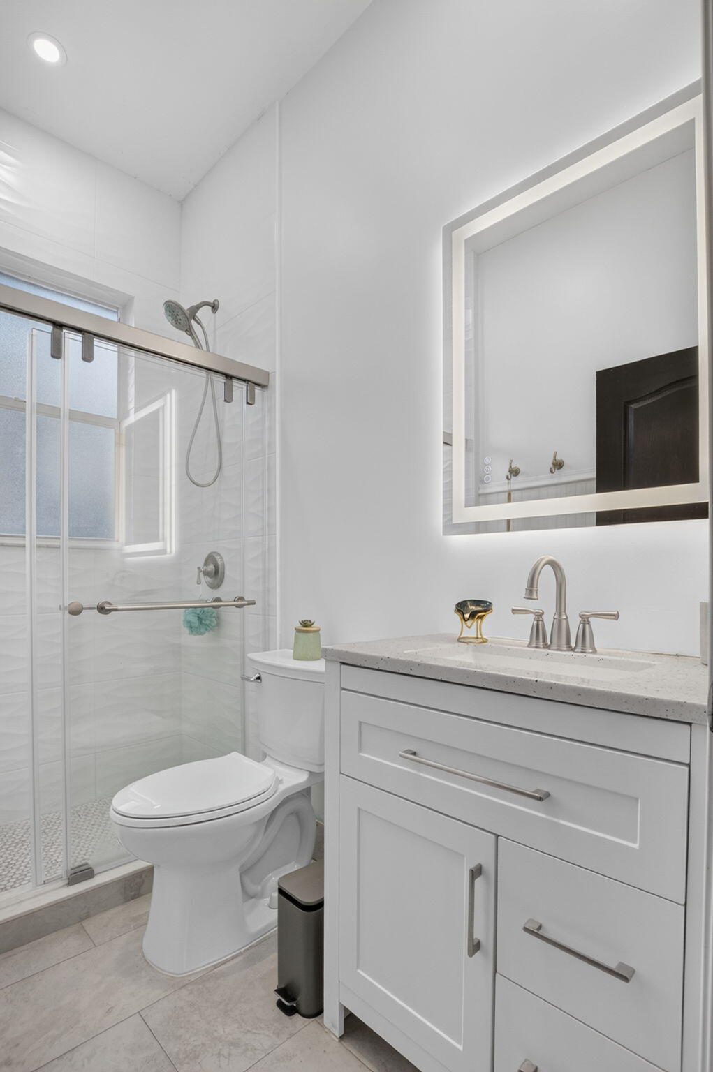 1365 East Barwick Ranch Circle Delray Beach, FL 33445 - Photo 47 of 77 a bathroom with a granite countertop sink a toilet and a mirror