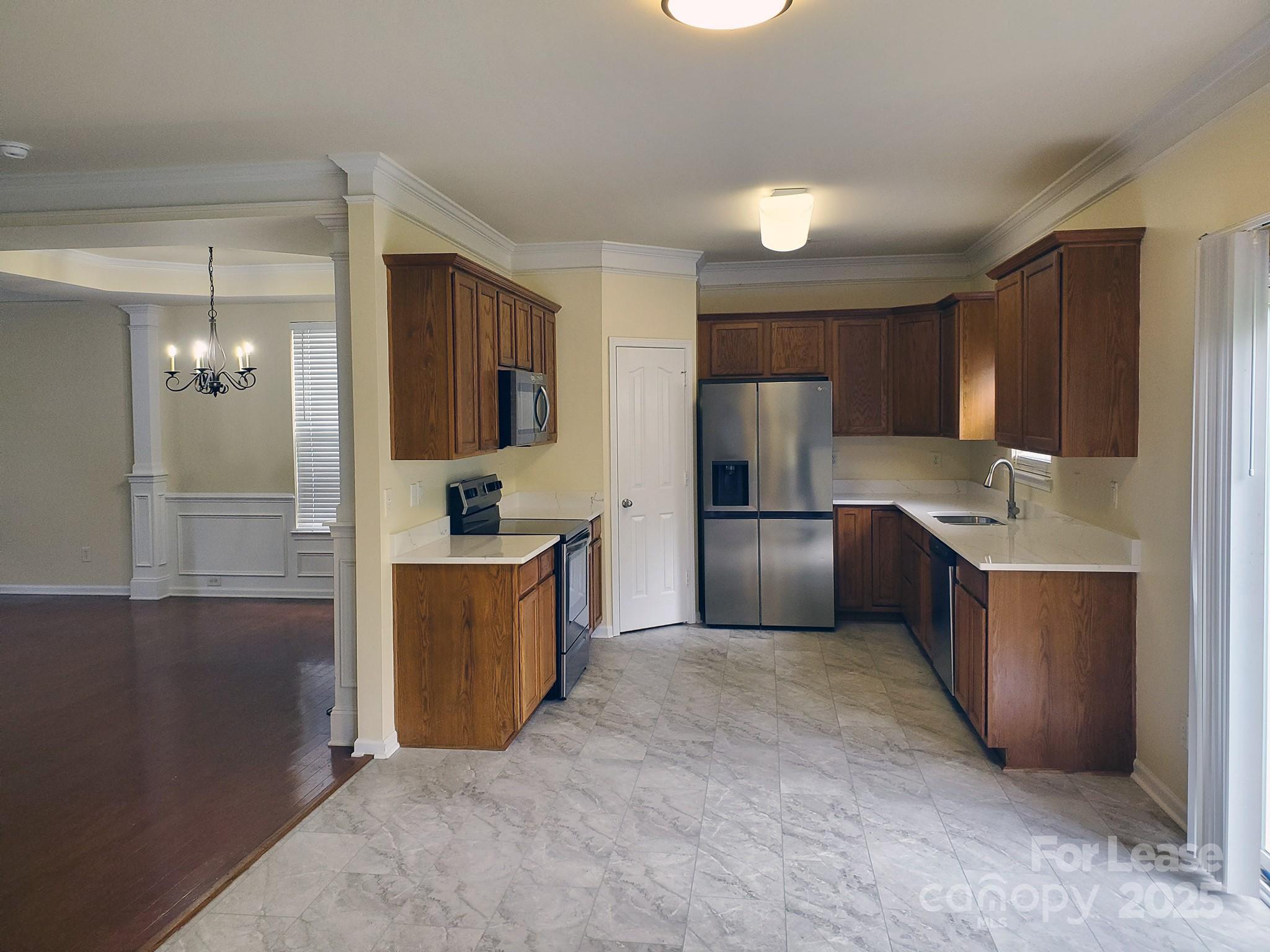 13008 Rothe House Road Charlotte, NC 28273 - Photo 13 of 26 a large kitchen with cabinets and stainless steel appliances