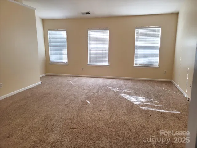 a view of an empty room with windows