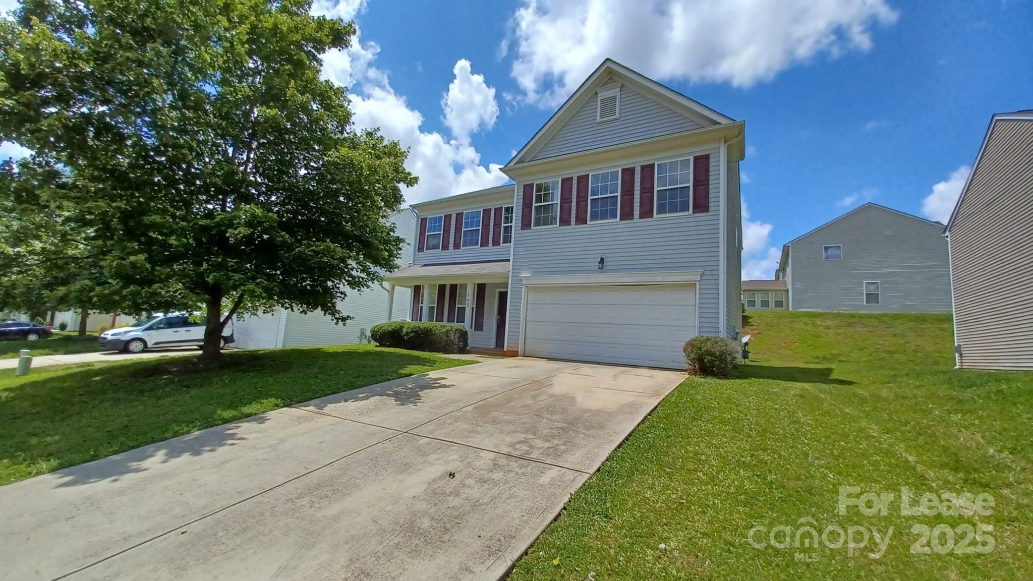 13008 Rothe House Road Charlotte, NC 28273 - Photo 26 of 26 a front view of a house with a yard and garage