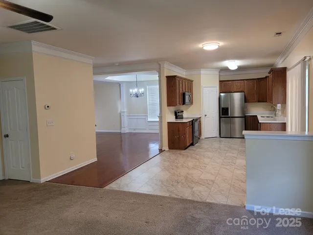 a view of a kitchen with a sink and a refrigerator