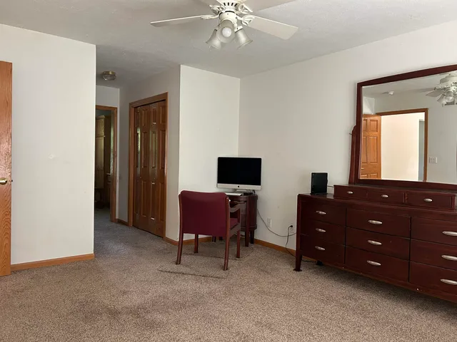 a room with a dresser and a chair