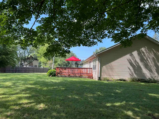 a front view of a house with a yard and a porch