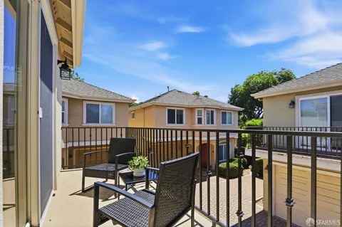 a view of a chair and table on the deck