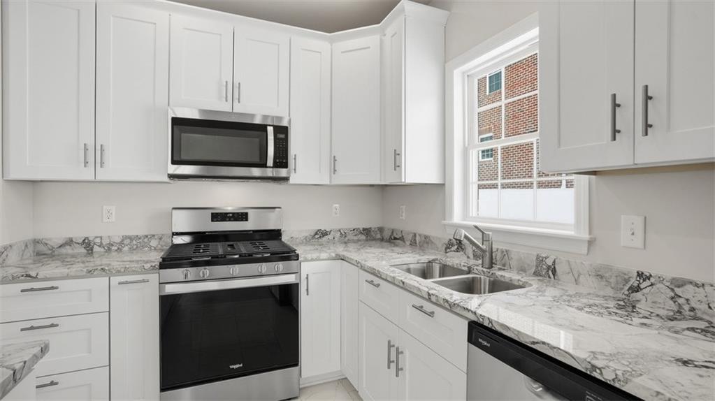 300 River Rdg Court Baden, PA 15005 - Photo 11 of 28 a kitchen with granite countertop white cabinets sink and stainless steel appliances