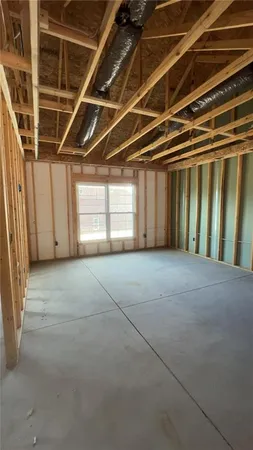 a spacious bedroom with a bed and chair