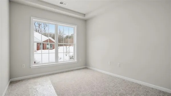 a view of livingroom with an empty room and window