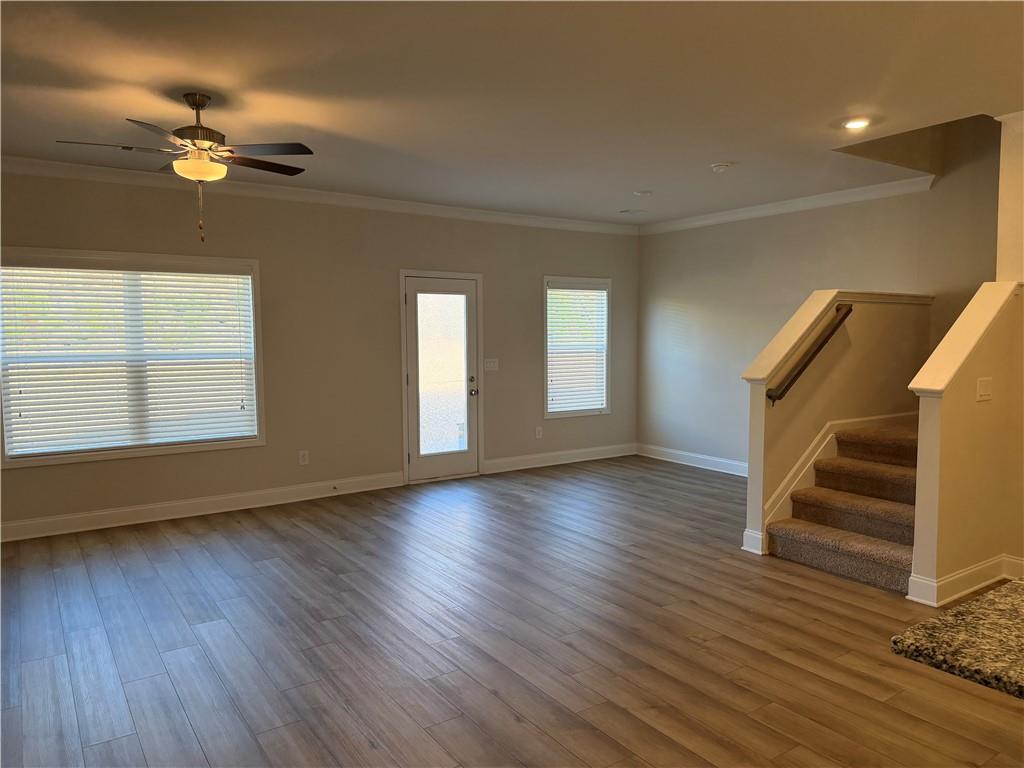 3772 Dover Run Lane Loganville, GA 30052 - Photo 14 of 36 a view of an empty room with wooden floor and fan