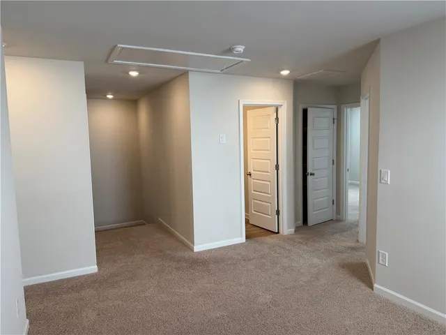 an empty room with closet and a bathroom