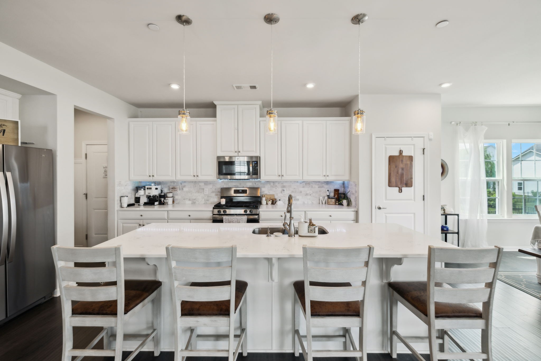 2030 Oglethorpe Drive Franklin, TN 37064 - Photo 20 of 54 a kitchen with stainless steel appliances kitchen island granite countertop a dining table chairs and white cabinets
