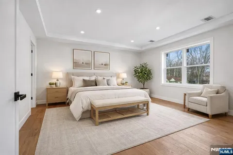 a spacious bedroom with a bed and a couch