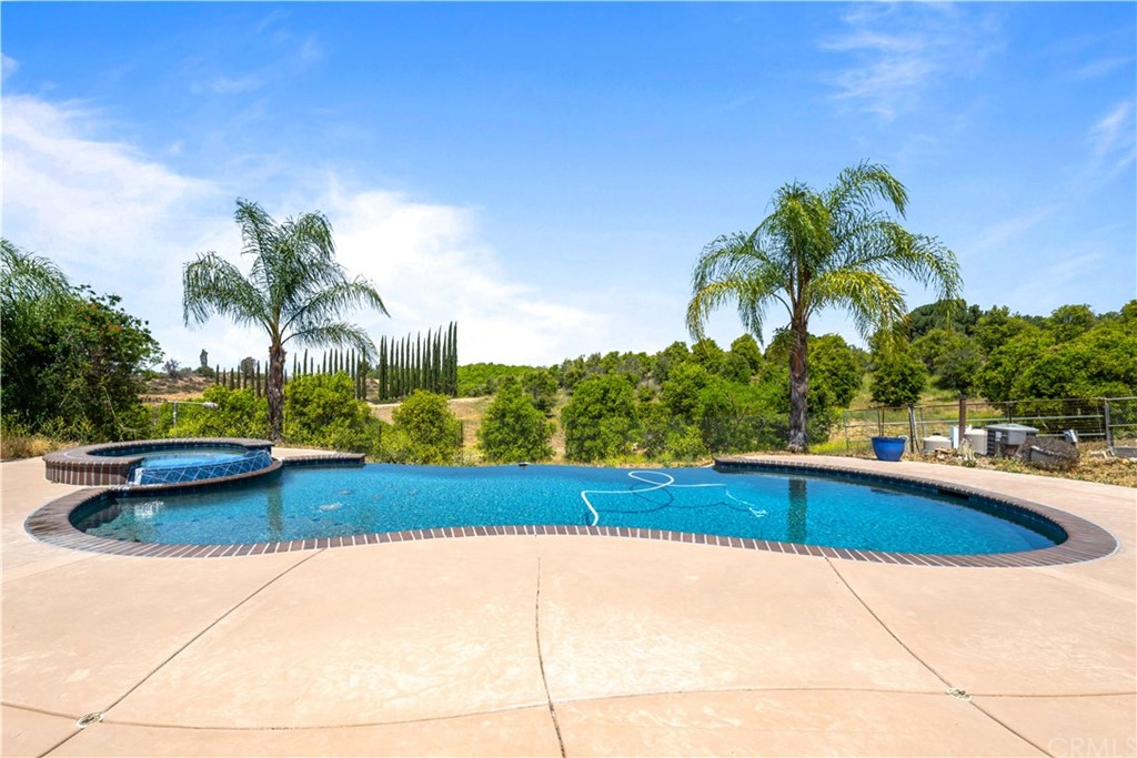 34970 Santa Rita Road Temecula, CA 92592 - Photo 16 of 38 a view of swimming pool with outdoor seating and plants