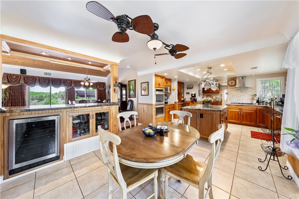 34970 Santa Rita Road Temecula, CA 92592 - Photo 20 of 38 a living room with stainless steel appliances kitchen island granite countertop a stove and a view of living room